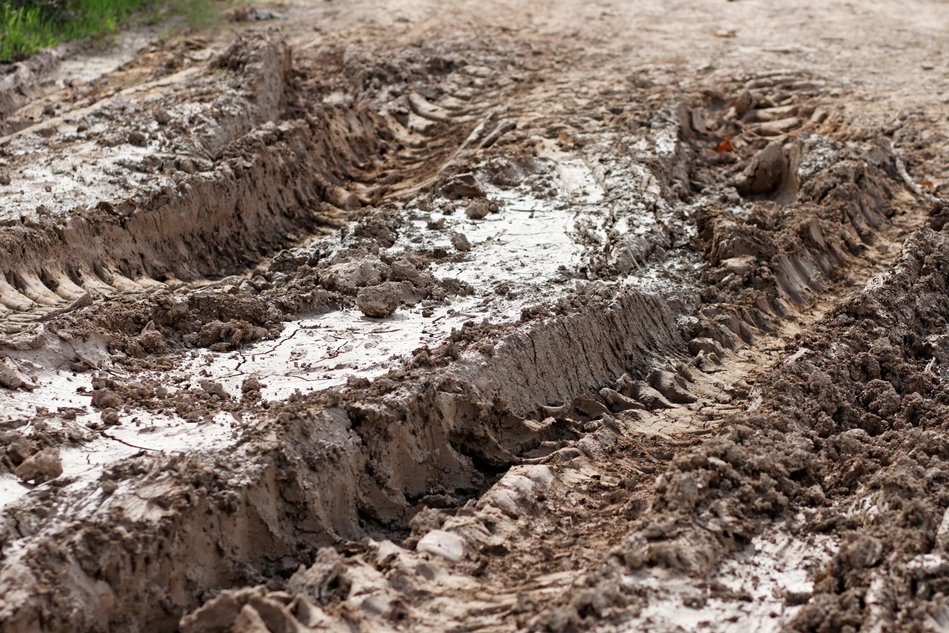 Closeup of car ruts in dry road mud